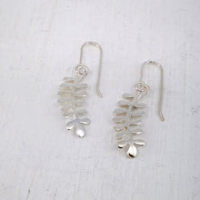 Load image into Gallery viewer, These light silver earrings are hand crafted in the shape of the NZ native Kowhai leaf. Made by Ruru Jewellery and available at Mason and Collins.
