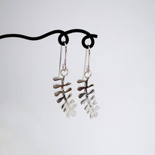 Load image into Gallery viewer, These light silver earrings are hand crafted in the shape of the NZ native Kowhai leaf. Made by Ruru Jewellery and available at Mason and Collins.
